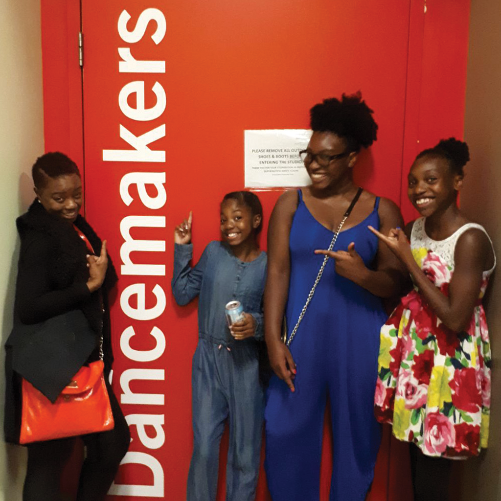 Roots & Branches Image - Dancers Stand In front Of DancemakersDoor