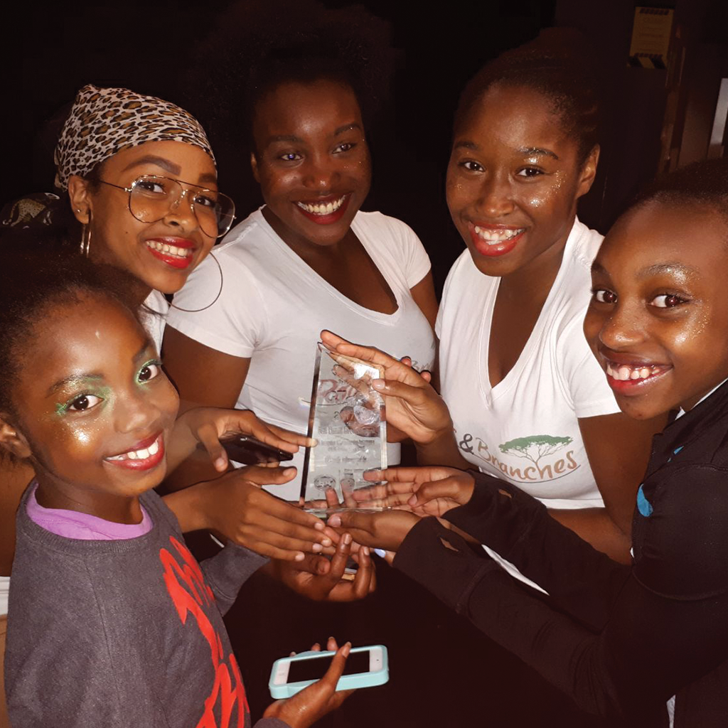 Roots & Branches Image - Group Of Dances Posing With The Prize